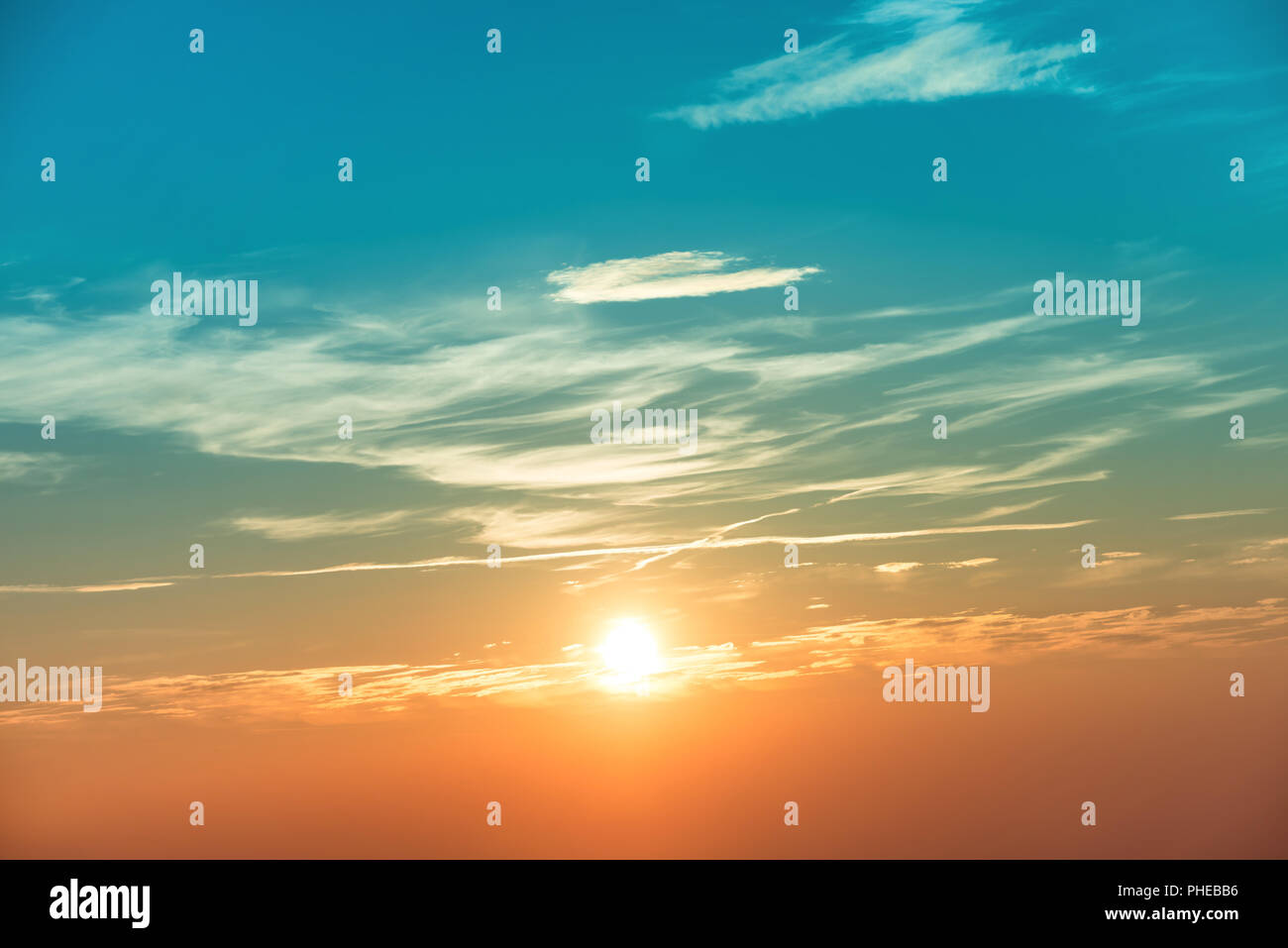Sunset in the sky with blue orange clouds Stock Photo - Alamy