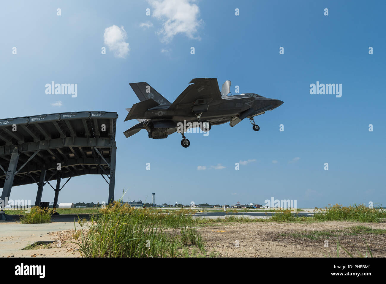 Royal Navy Cmdr. Nathan Gray and U.S. Marine Corps Maj. Michael Lippert, both F-35 Pax River ITF test pilots, conduct ski jumps and field carrier landing practices with F-35Bs on Aug. 28, 2018, at NAS Patuxent River as part of the workups for the First of Class Flight Trials aboard the HMS Queen Elizabeth.  Around 200 supporting staff from the ITF, including pilots, engineers, maintainers and data analysts, will take two F-35Bs test aircraft aboard HMS Queen Elizabeth this fall to evaluate the fifth-generation aircraft performance and integration with Royal Navy’s newest aircraft carrier. This Stock Photo