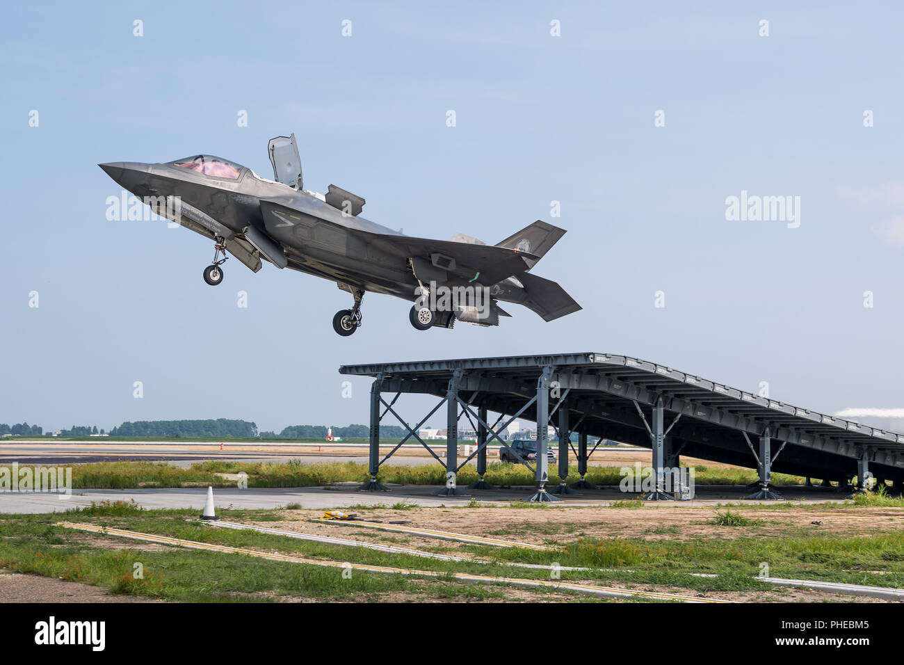 Royal Navy Cmdr. Nathan Gray and U.S. Marine Corps Maj. Michael Lippert, both F-35 Pax River ITF test pilots, conduct ski jumps and field carrier landing practices with F-35Bs on Aug. 28, 2018, at NAS Patuxent River as part of the workups for the First of Class Flight Trials aboard the HMS Queen Elizabeth.  Around 200 supporting staff from the ITF, including pilots, engineers, maintainers and data analysts, will take two F-35Bs test aircraft aboard HMS Queen Elizabeth this fall to evaluate the fifth-generation aircraft performance and integration with Royal Navy’s newest aircraft carrier. This Stock Photo