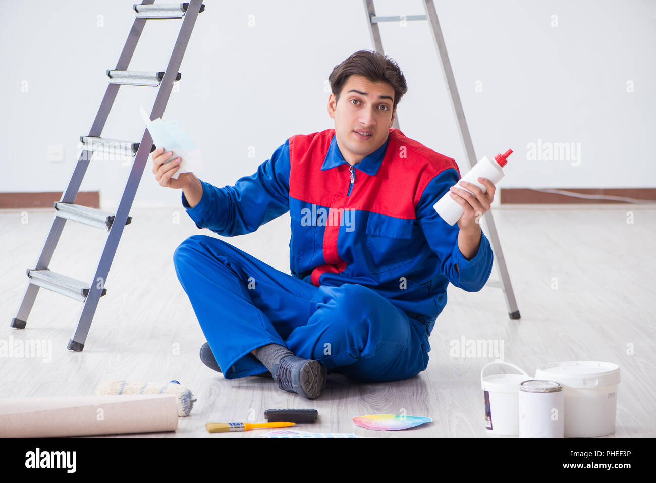 Young painter trying to match colours for painting job Stock Photo Alamy