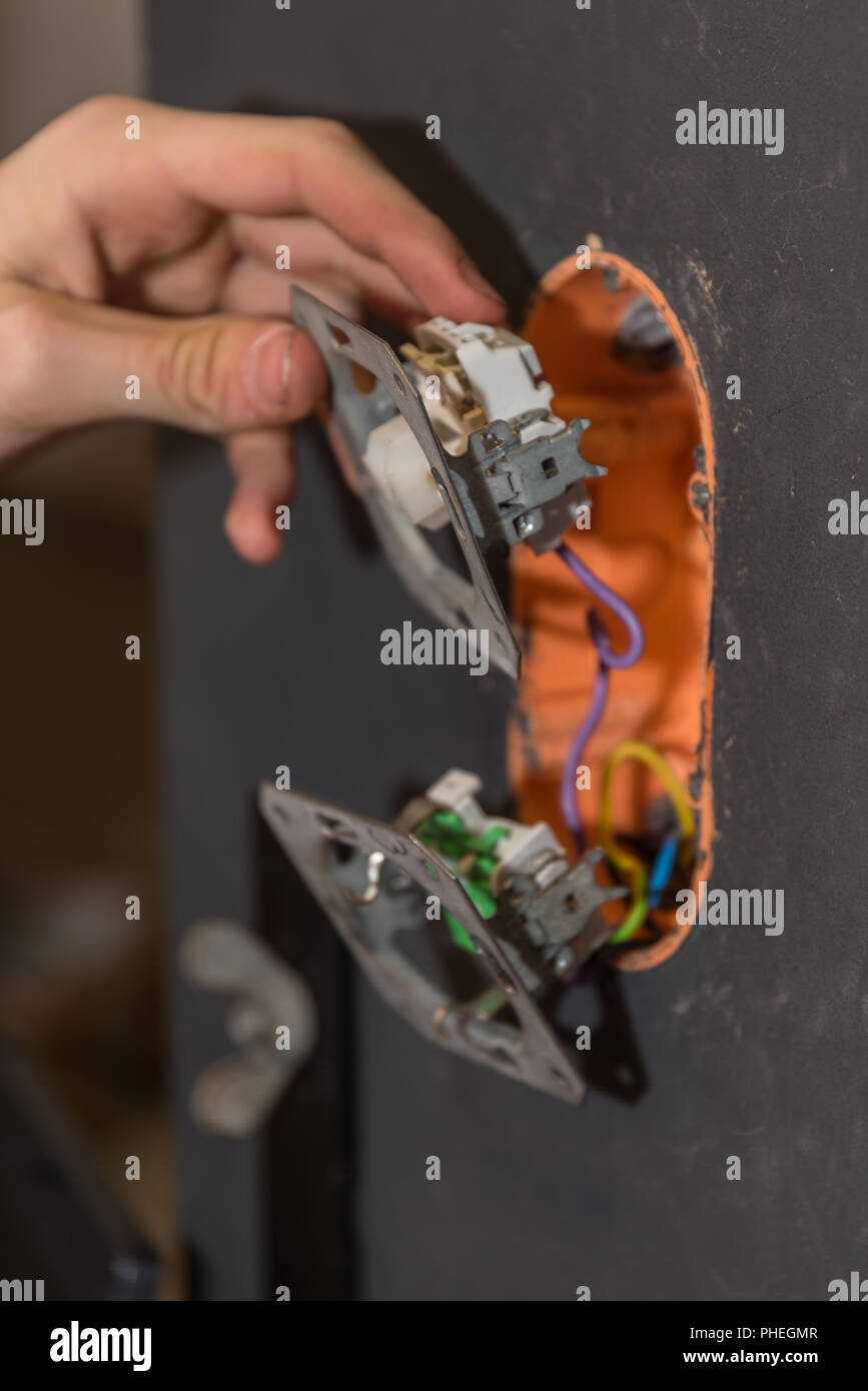 Installing electrical circuits on a wall - close-up Stock Photo