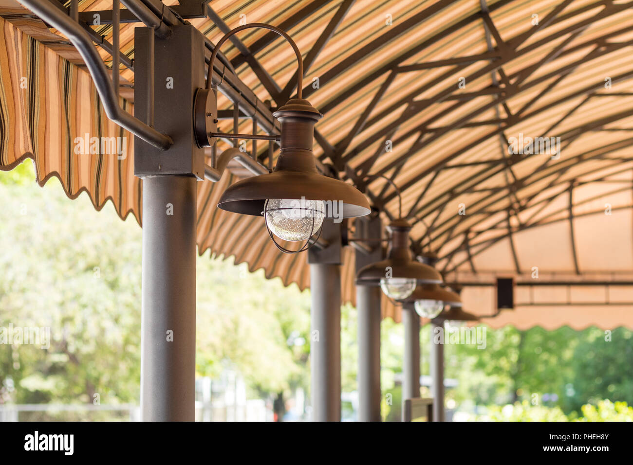 Streetlights under the summer cafeteria canopy. Architectural composition Stock Photo
