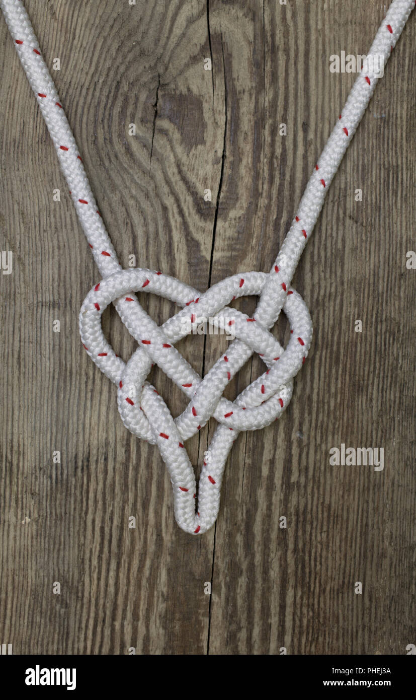 marine rope knot in the form of heart Stock Photo