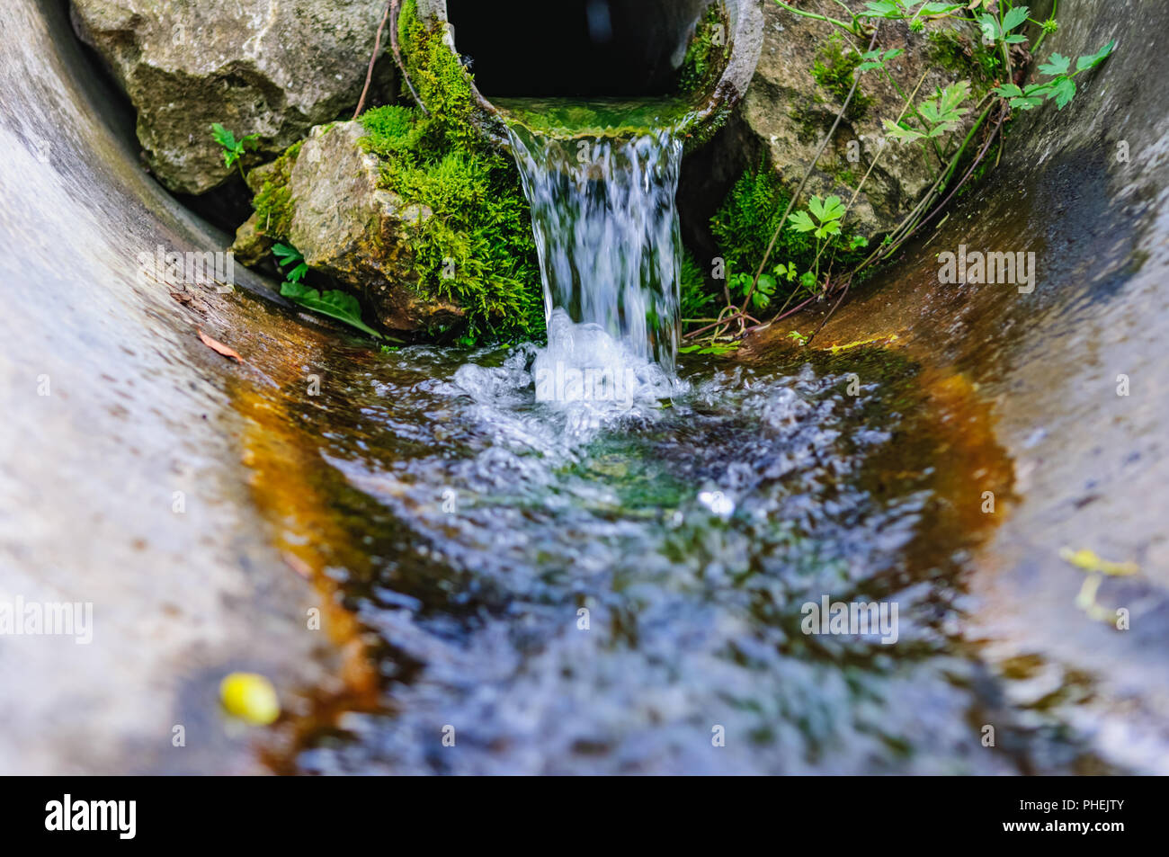 flowing water spring pipe Stock Photo