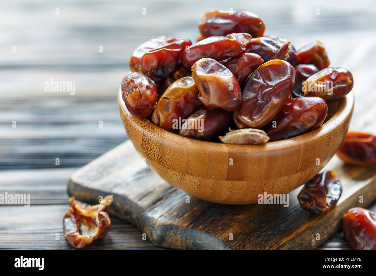 Dried date fruit in a wooden bowl. Stock Photo