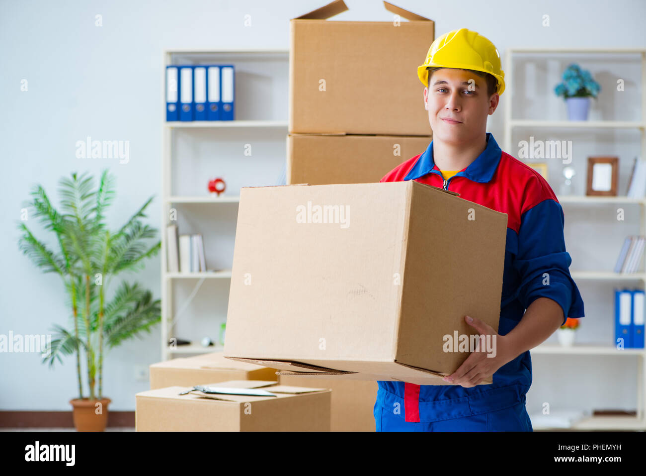 Young man working in relocation services with boxes Stock Photo - Alamy