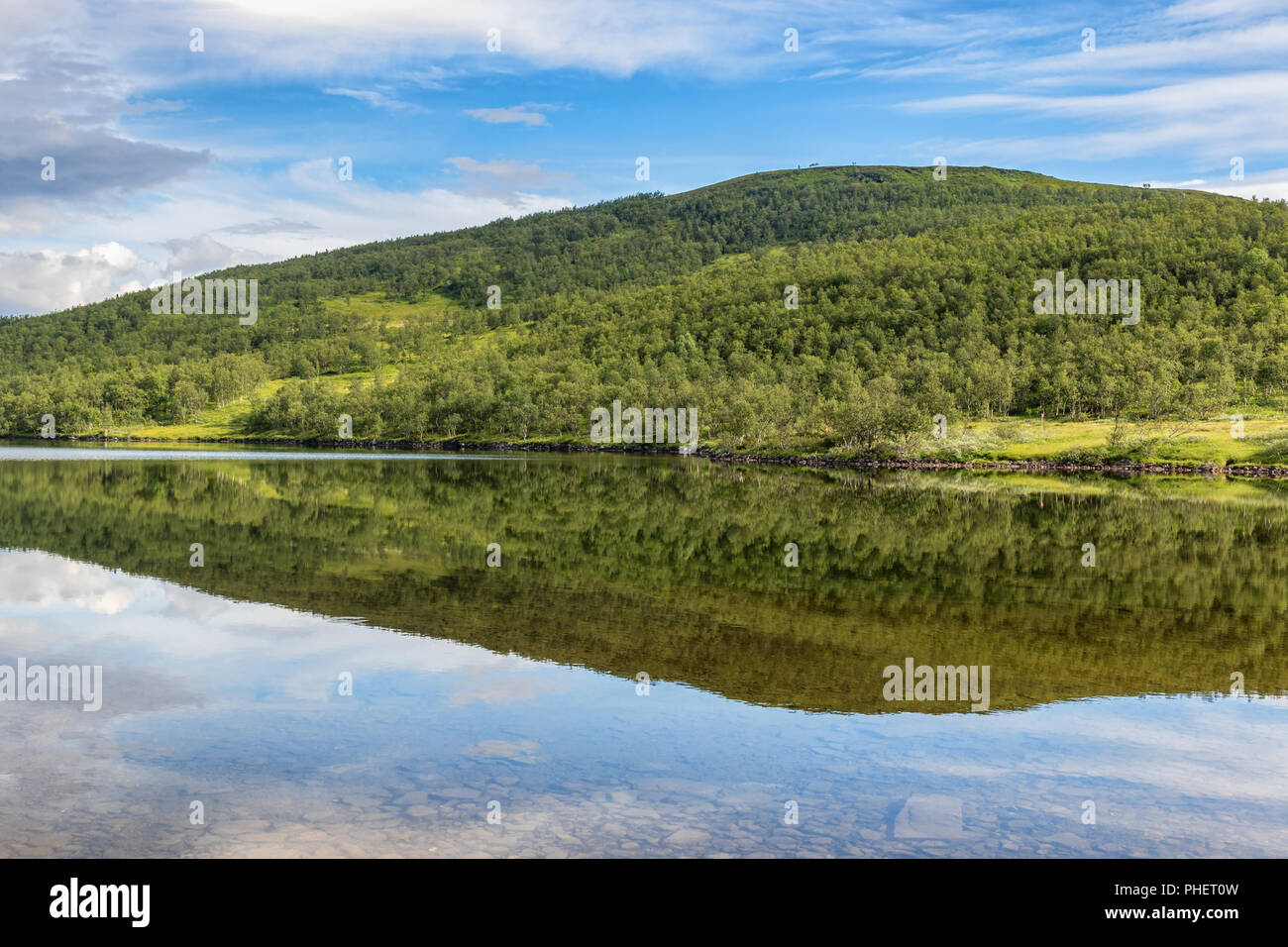 Lake with water reflections at a forest hill Stock Photo - Alamy