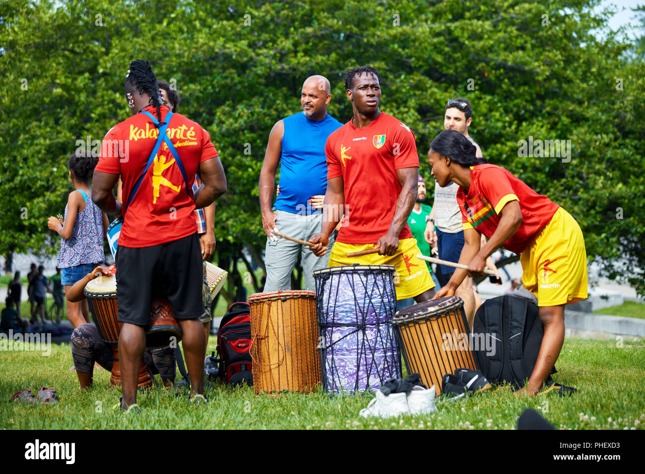 African American male and female percussionists playing djembe and dunun drums at Tam Tams festival in Mount Royal Park, Montreal, Quebec, Canada. Stock Photo