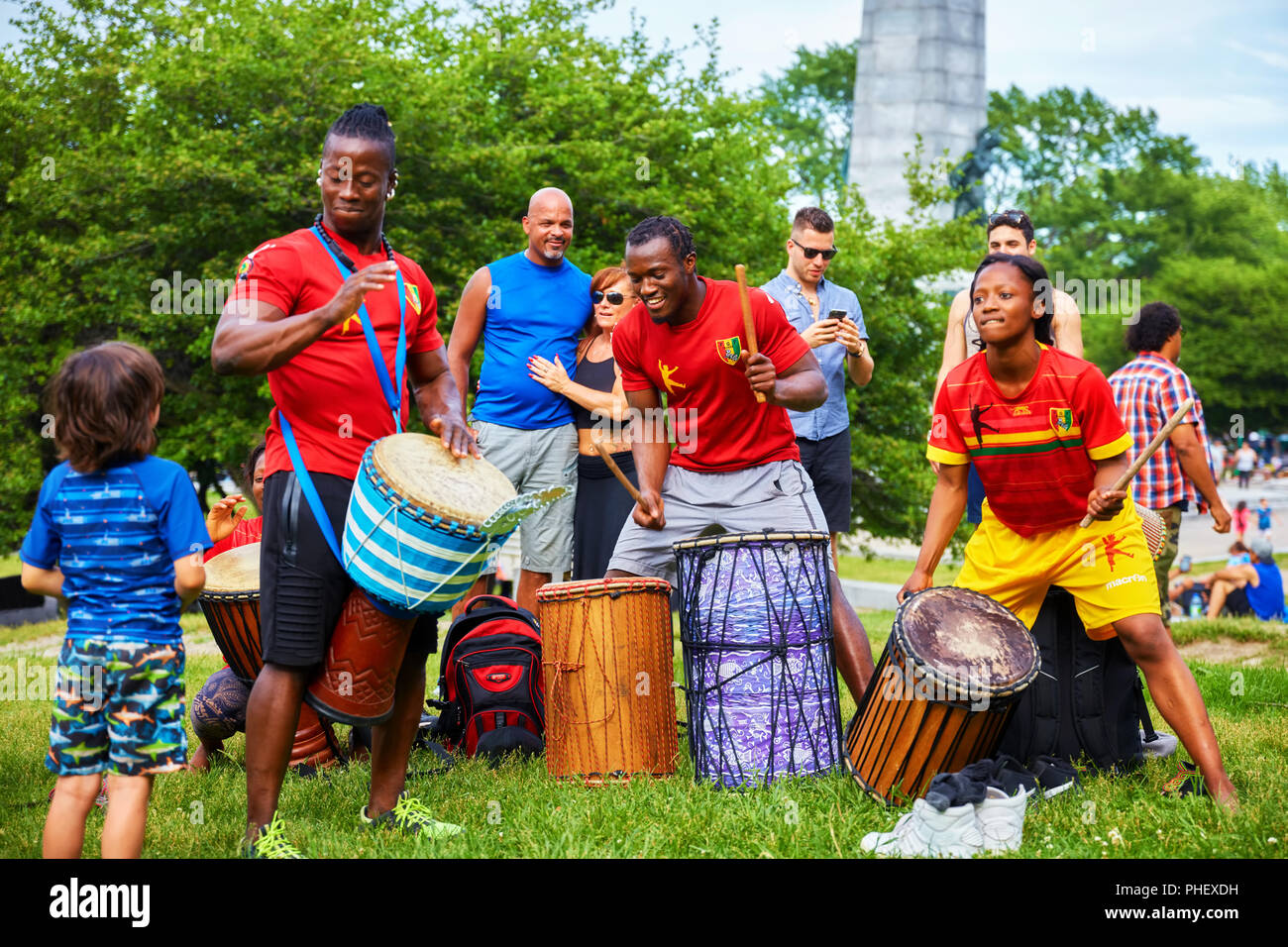 African American male and female percussionists playing djembe and dunun drums at Tam Tams festival in Mount Royal Park, Montreal, Quebec, Canada. Stock Photo