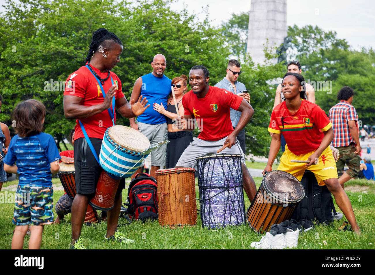 African American male and female percussionists playing djembe and dunun drums at Tam Tams festival in Mount Royal Park, Montreal, Quebec, Canada. Stock Photo