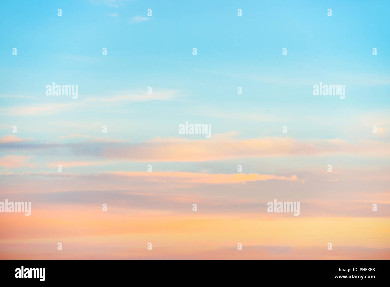 Pale sunset sky with pink, orange and red colors Stock Photo