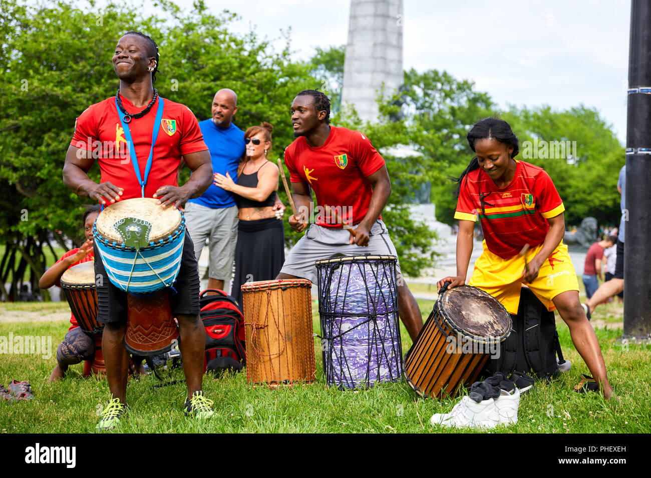 African American male and female percussionists playing djembe and dunun drums at Tam Tams festival in Mount Royal Park, Montreal, Quebec, Canada. Stock Photo