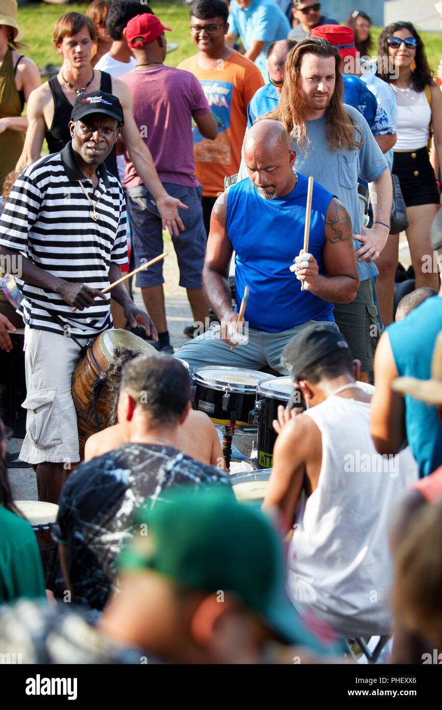African American drummer and percussionists playing in front of the