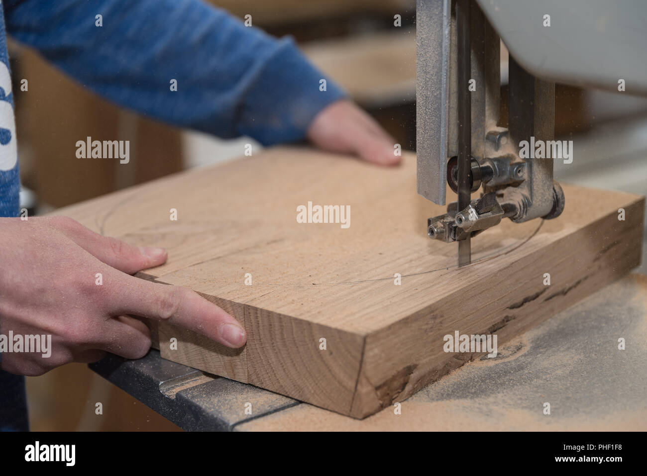 Joiner cuts with a band saw - close-up Stock Photo