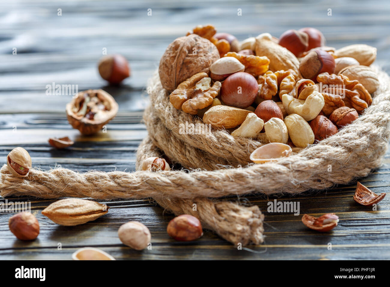 Hemp rope and a mixture of nuts. Stock Photo