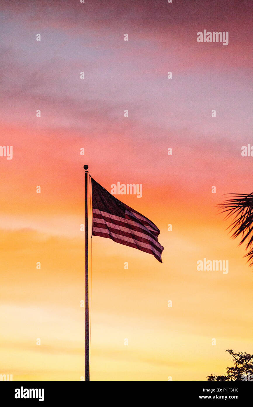 American flag blows in the wind  at sunrise Stock Photo