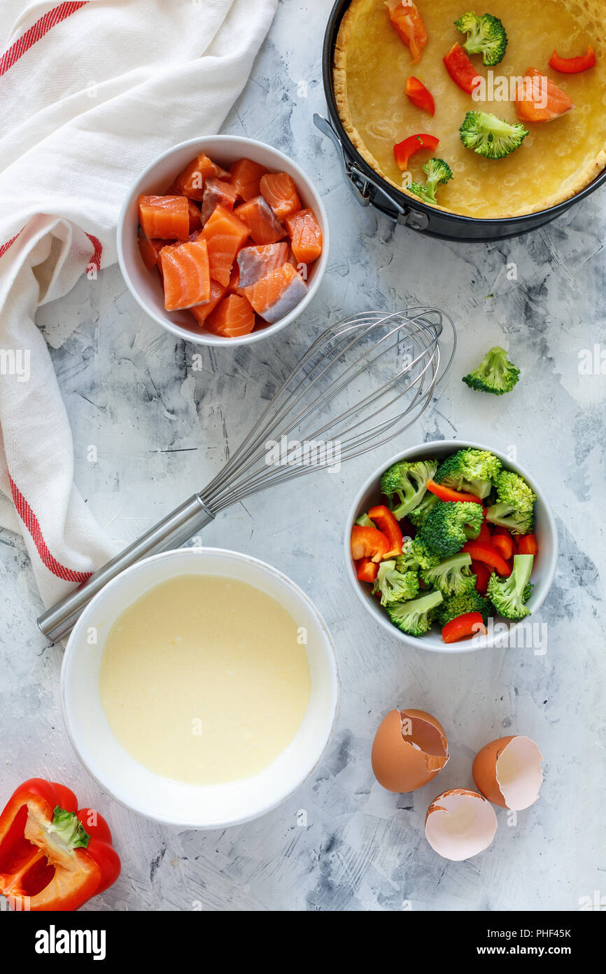 Ingredients to prepare pie with salmon and broccoli. Stock Photo