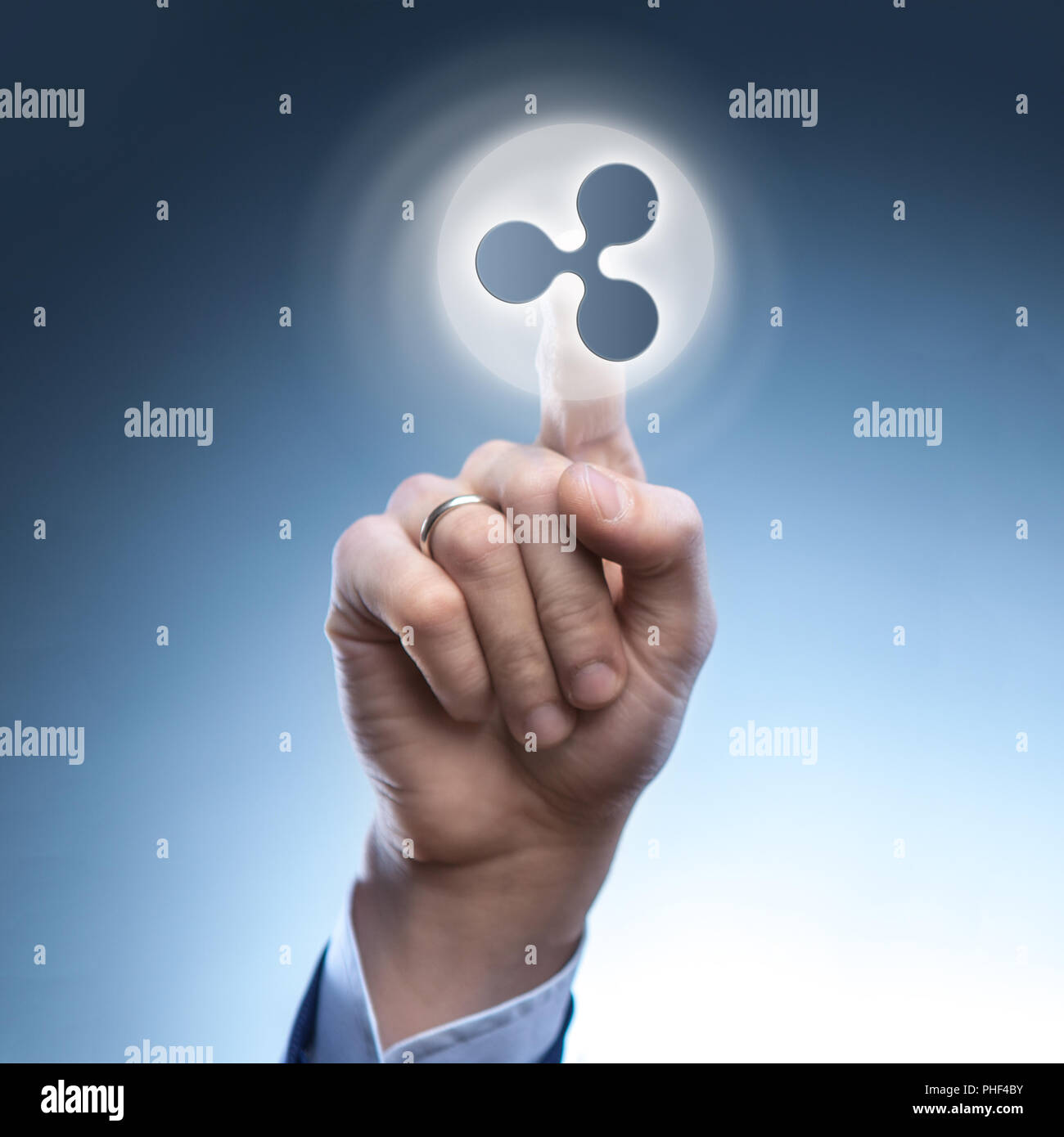 the hand of a man touches a ripple icon Stock Photo