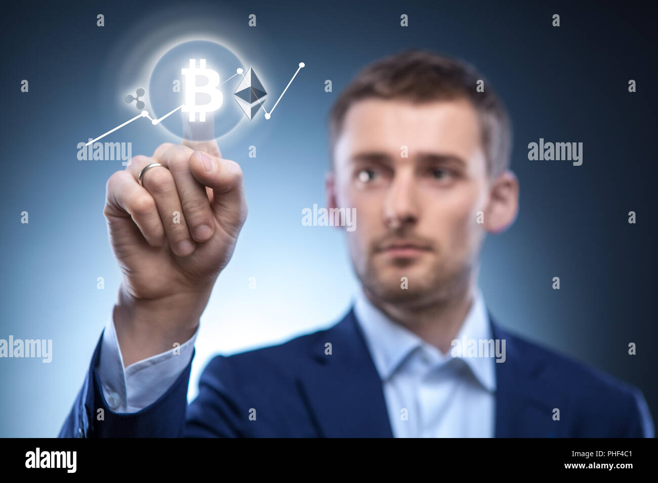 the man clicks Icon Bitcoin on virtual screen. Stock Photo