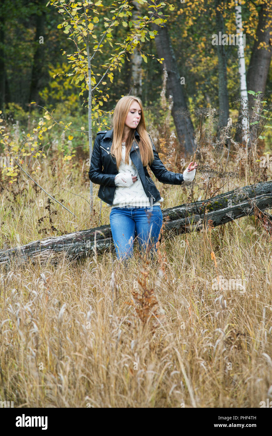 The girl in a leather jacket among a yellow grass Stock Photo