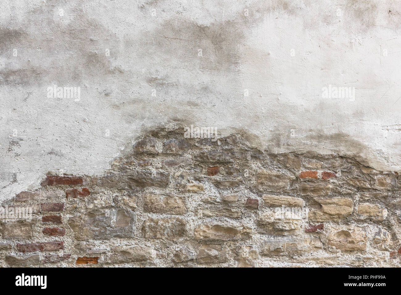 Partially newly plastered brick wall Stock Photo