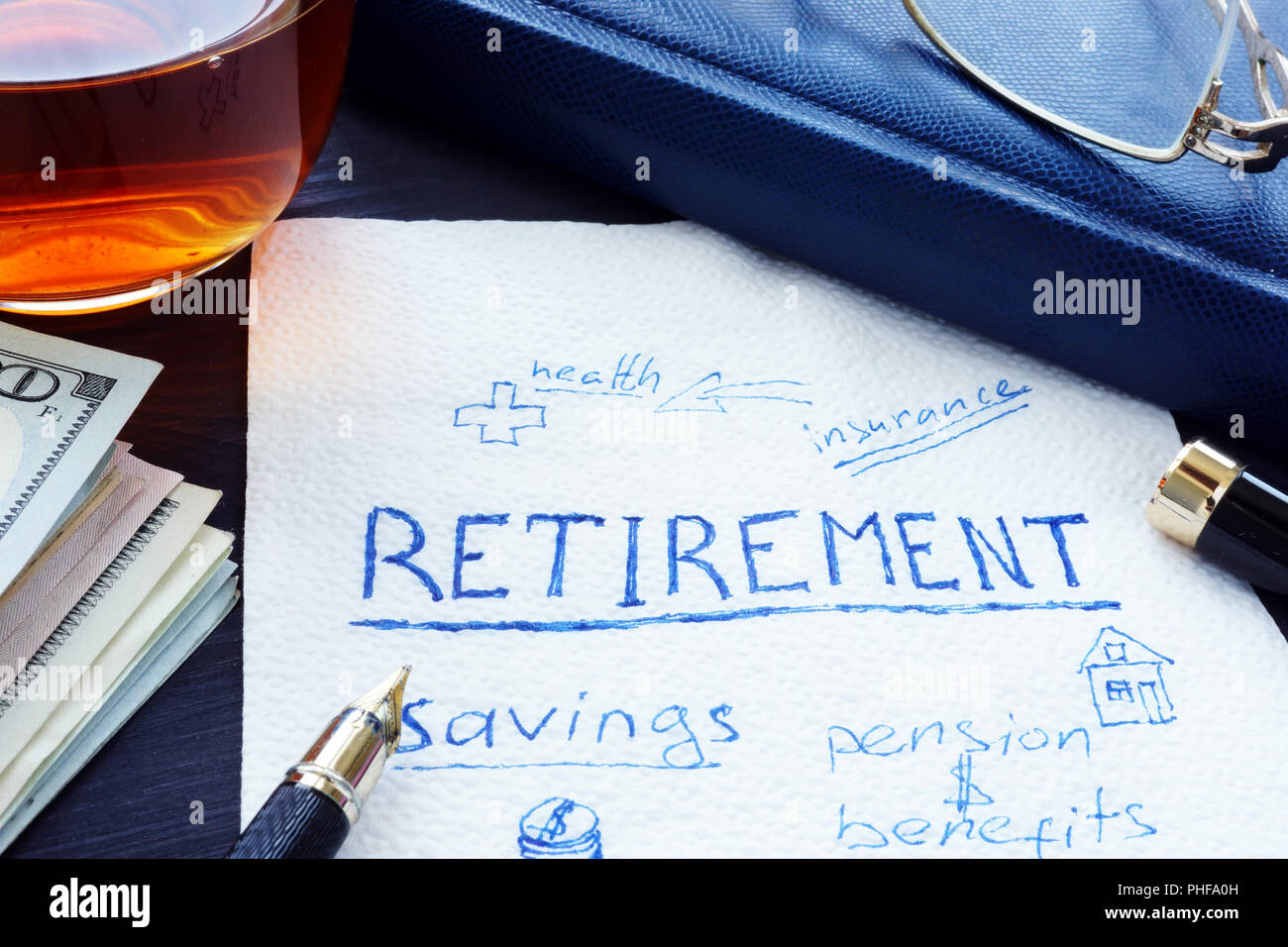 Retirement plan handwritten on a napkin. Savings for pension. Stock Photo