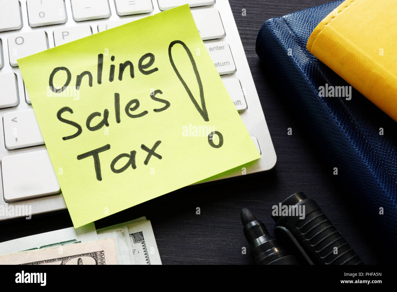Online sales tax on a keyboard and money. Stock Photo