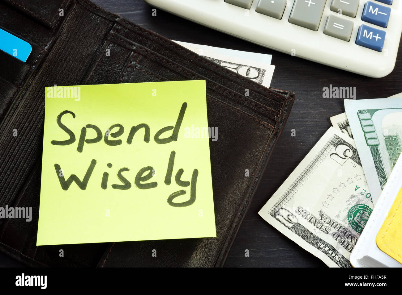 Open wallet with memo spend wisely. Money habits. Stock Photo