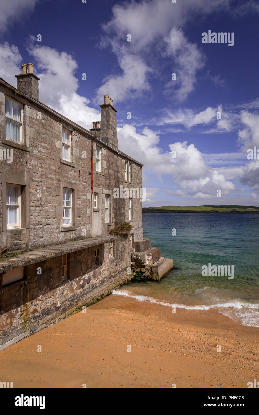 Old stone house by the sea at Lerwick, Shetland Isles, Scotland on a sunny day Stock Photo