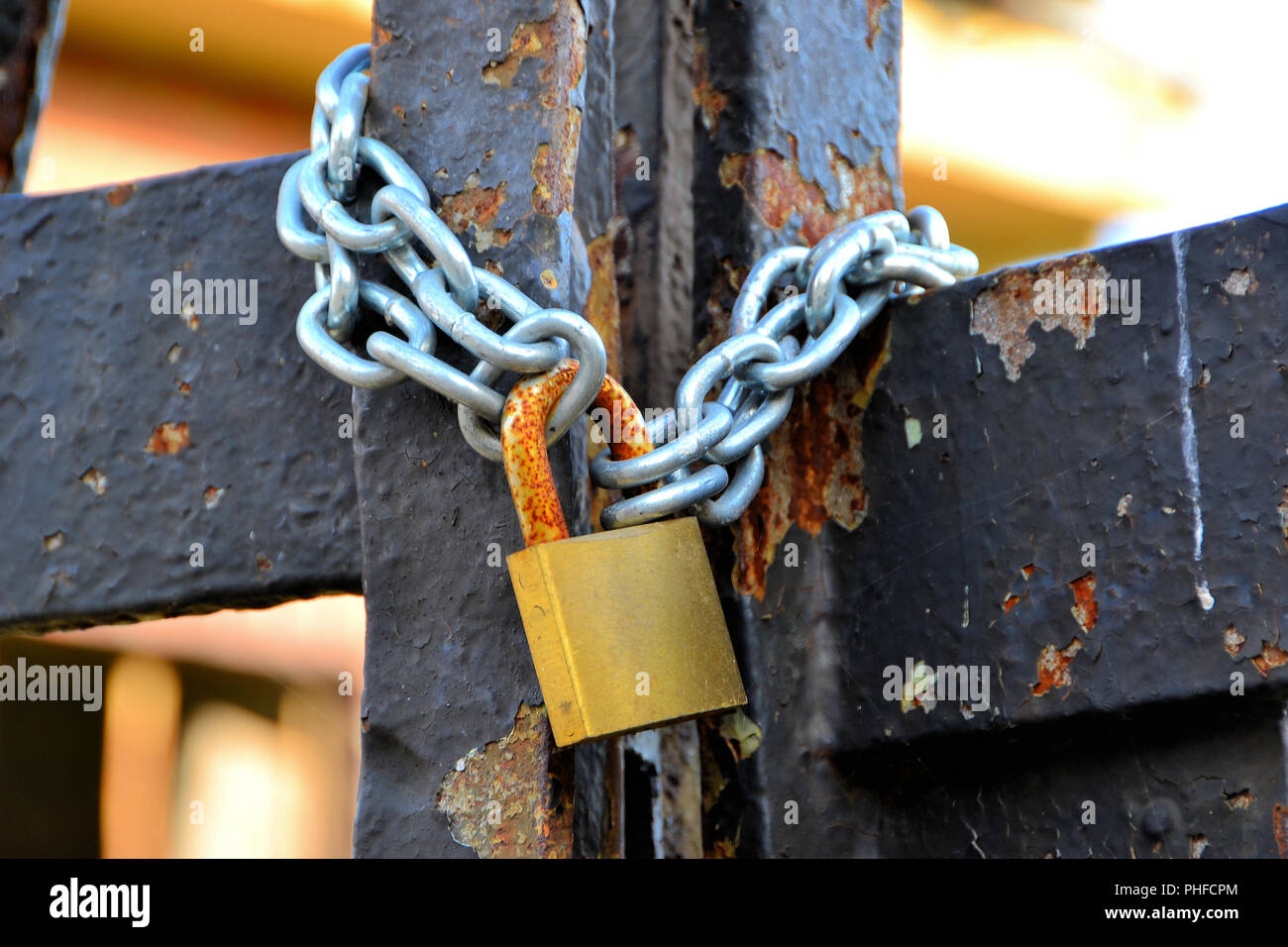 Padlock at the gate of an abandoned factory Stock Photo