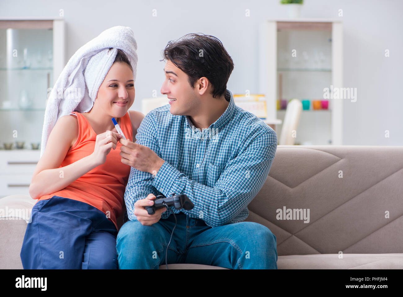 Wife and husband looking at pregnancy test Stock Photo