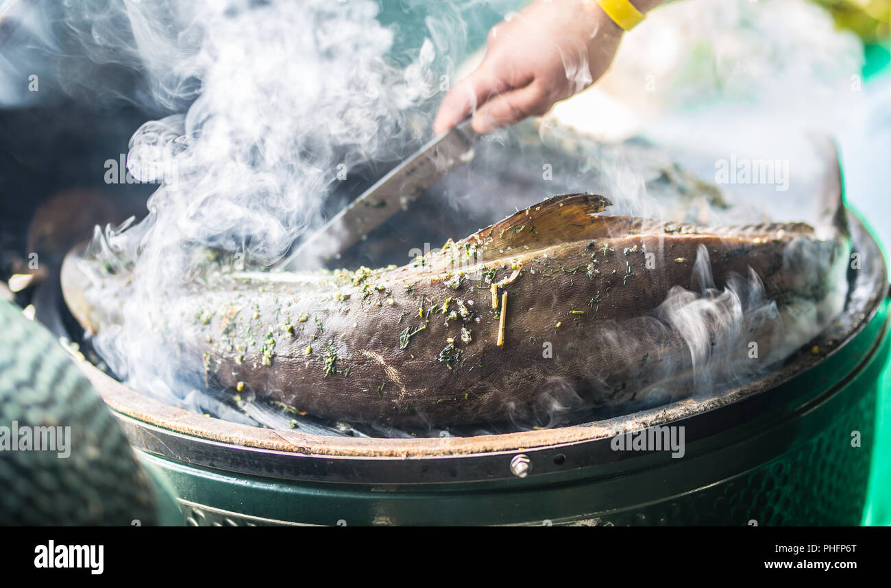 Smoked fish garden grill and smoke the process of smoking Stock Photo