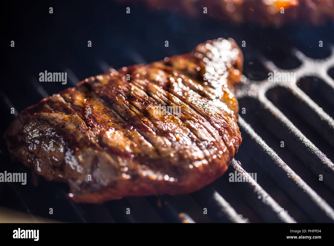 Closeup Beef flank steak cooking on grill Stock Photo Alamy