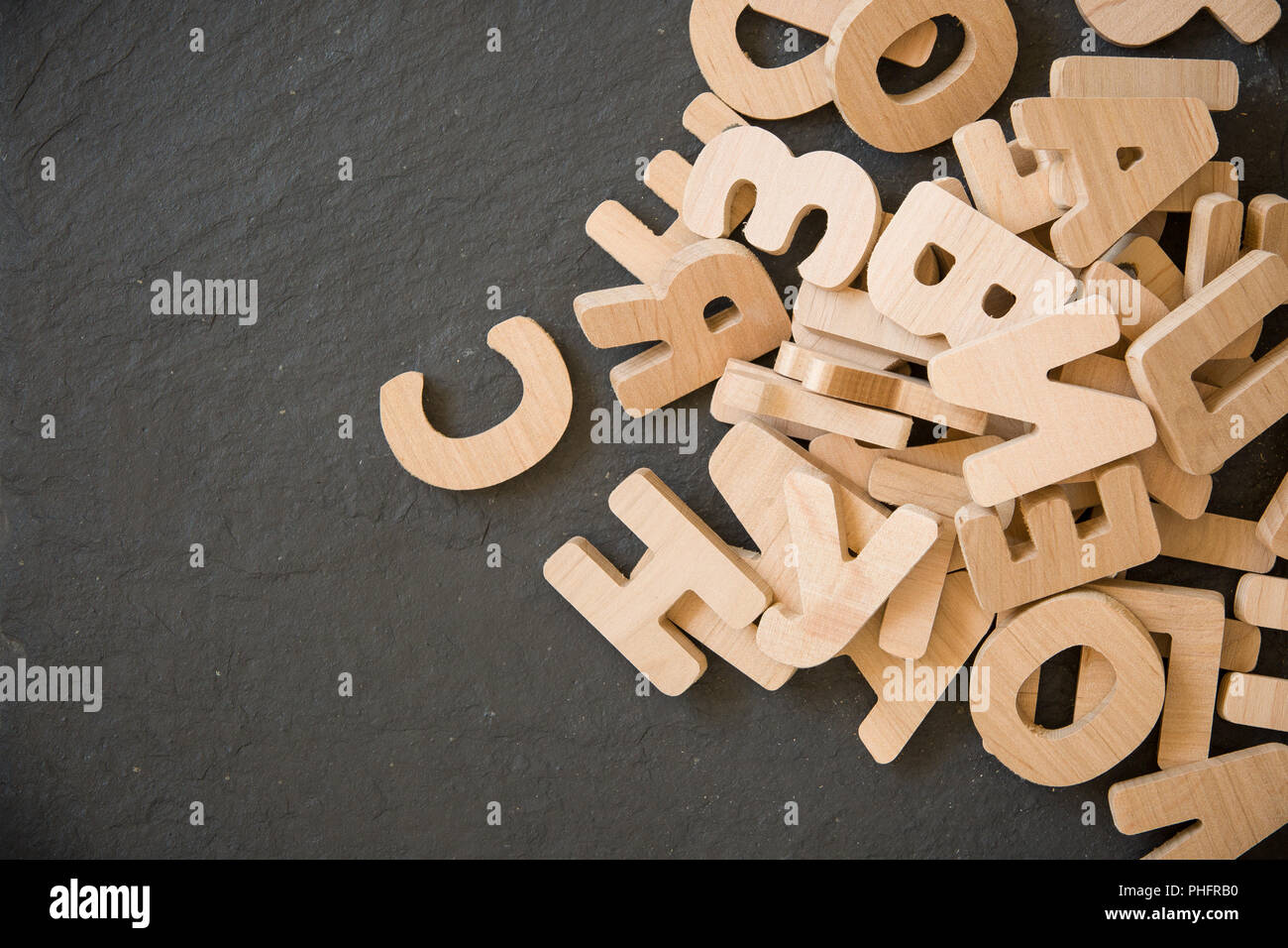 Get Many Letters Many wooden letters on black background. Copy space Stock Photo - Alamy