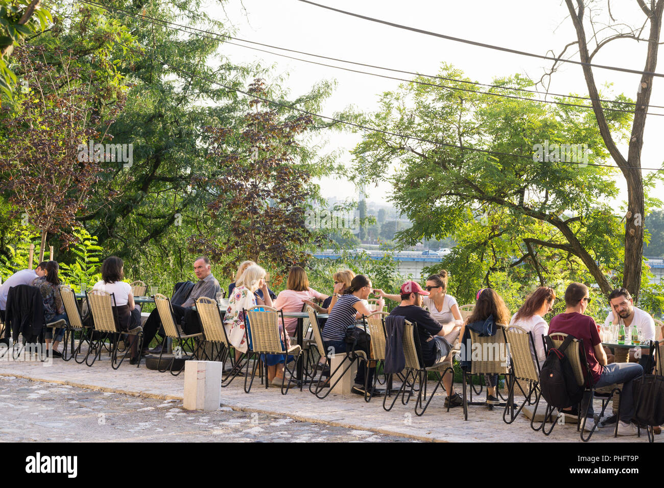People enjoying afternoon sun at the Skica cafe in the Kosancicev venac area of Belgrade, Serbia. Stock Photo