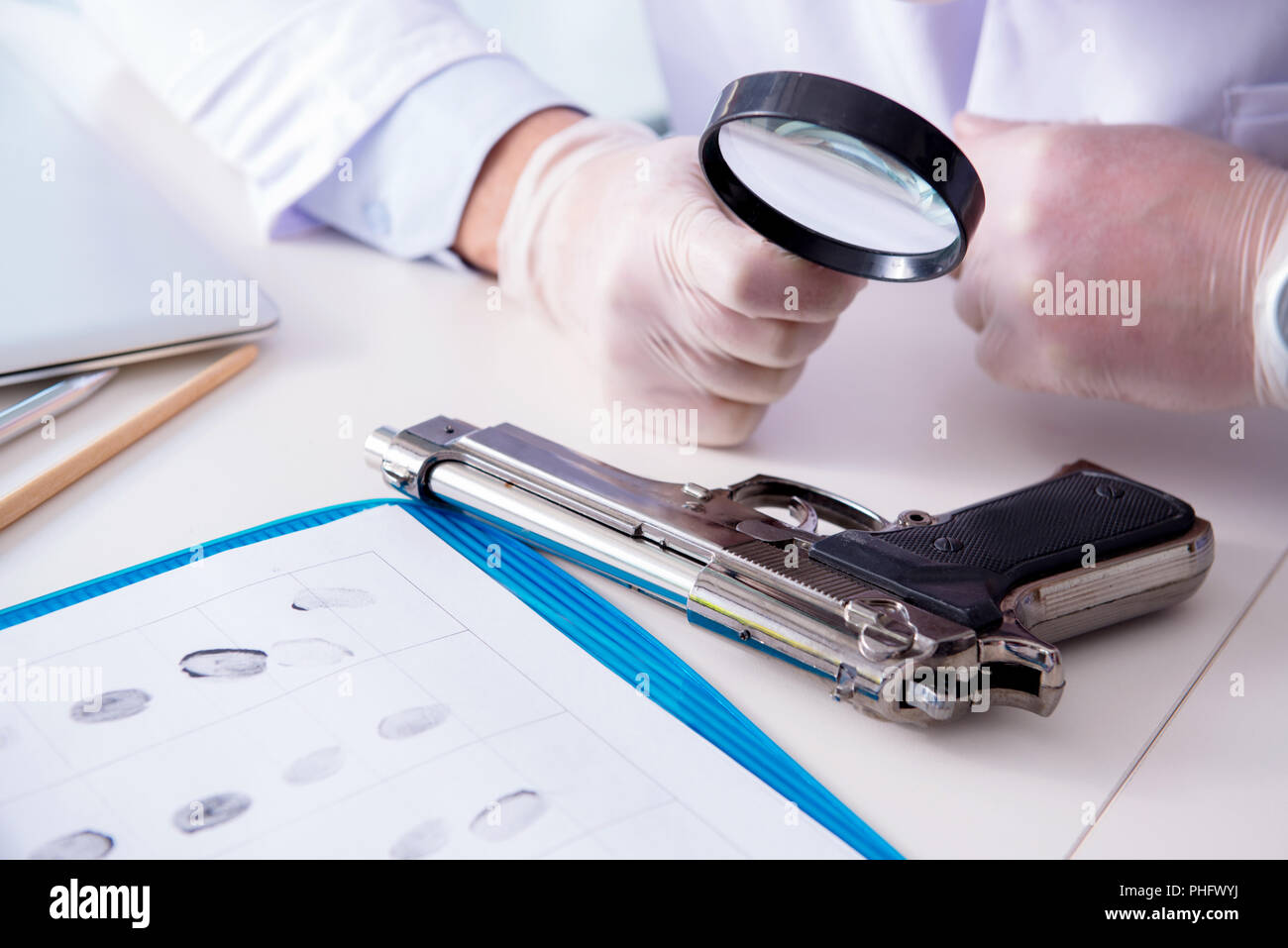 Criminologist police chemist looking at crime evidence Stock Photo - Alamy