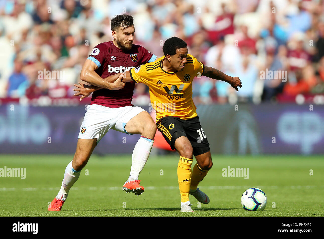 West Ham United's Robert Snodgrass (left) and Wolverhampton Wanderers' Helder Costa battle for the ball during the Premier League match at London Stadium. Stock Photo