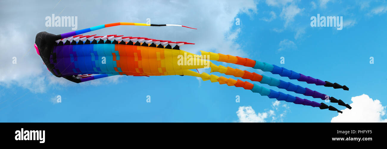 Big Chinese dragon kite in the blue sky and clouds Stock Photo