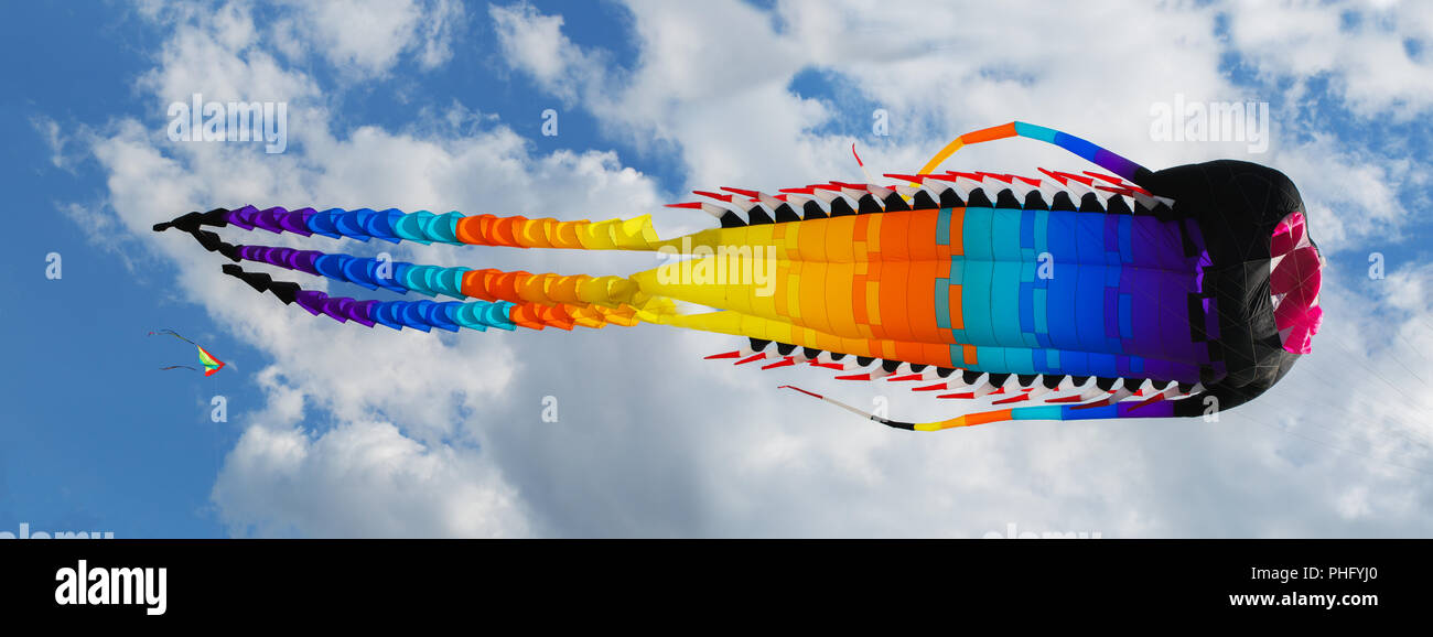 Big Chinese dragon kite in the blue sky and clouds Stock Photo