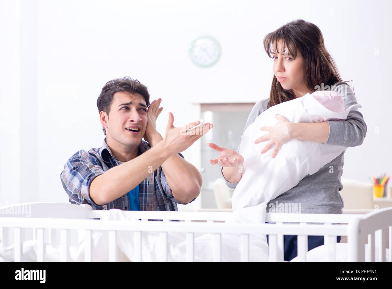Young dad cannot stand baby crying Stock Photo - Alamy