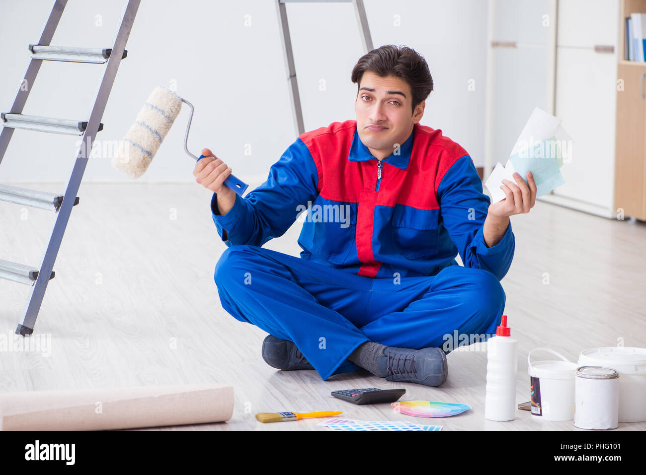 Young painter trying to match colours for painting job Stock Photo Alamy