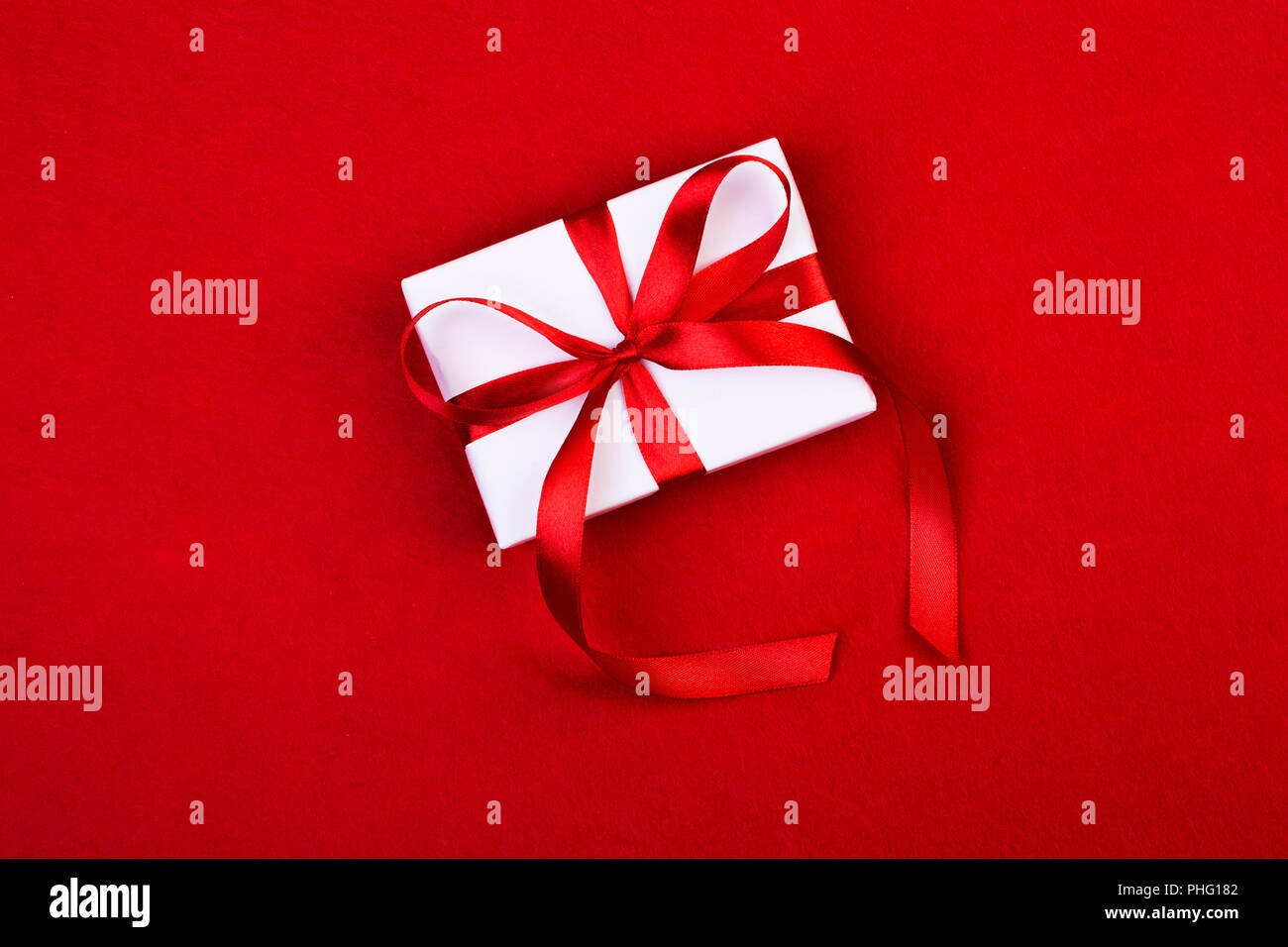 white gift boxes on red background Stock Photo - Alamy
