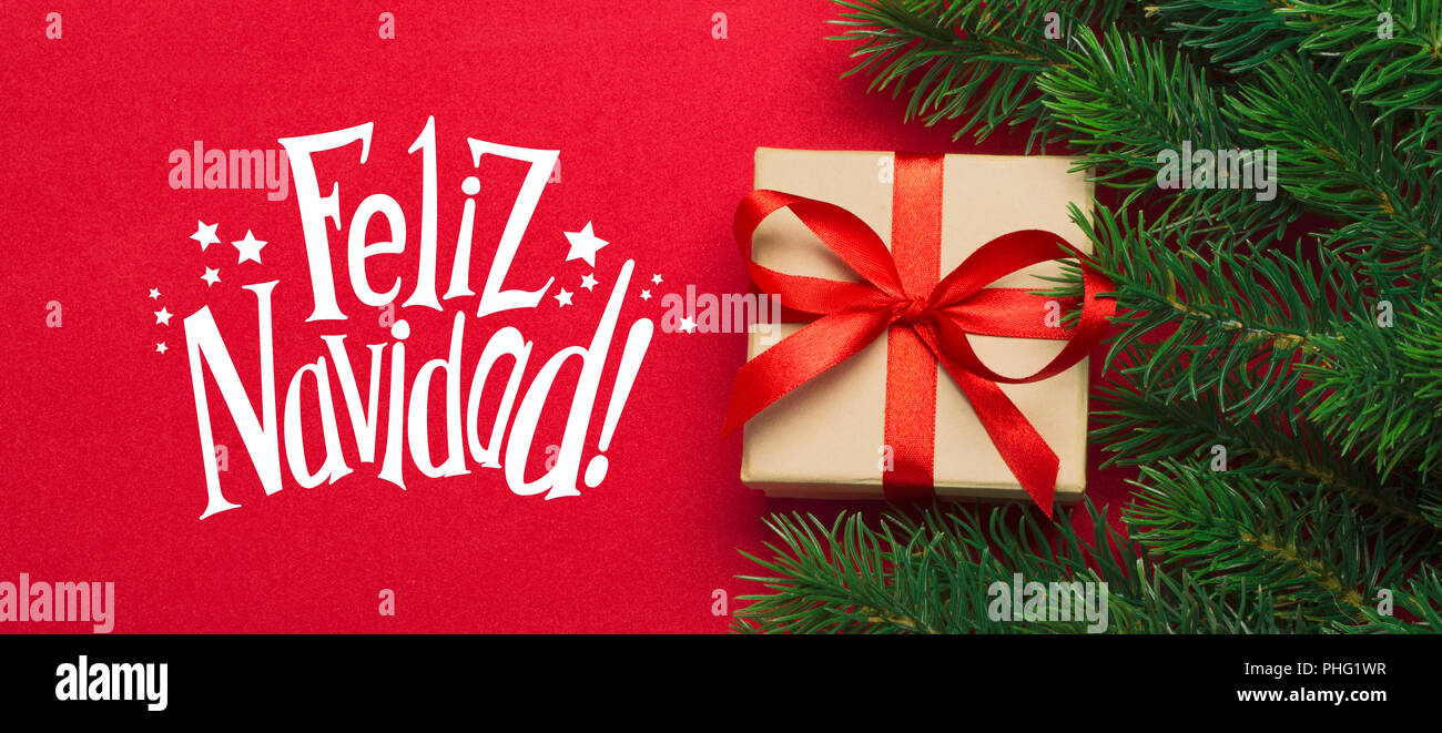 Branches of a Christmas tree and gift on a red background Stock Photo ...