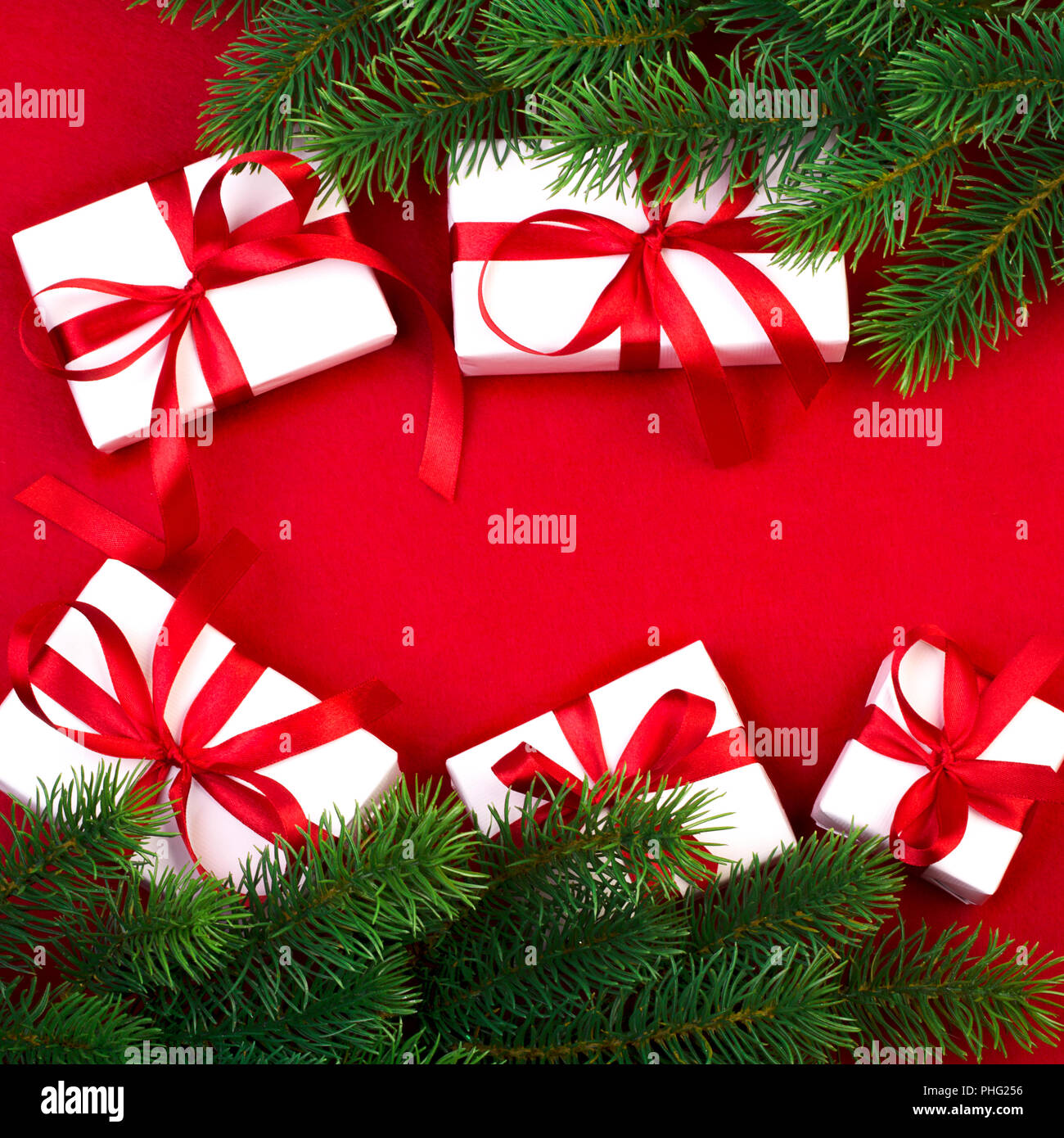 White gift boxes with a red ribbon on a red background surrounded by ...