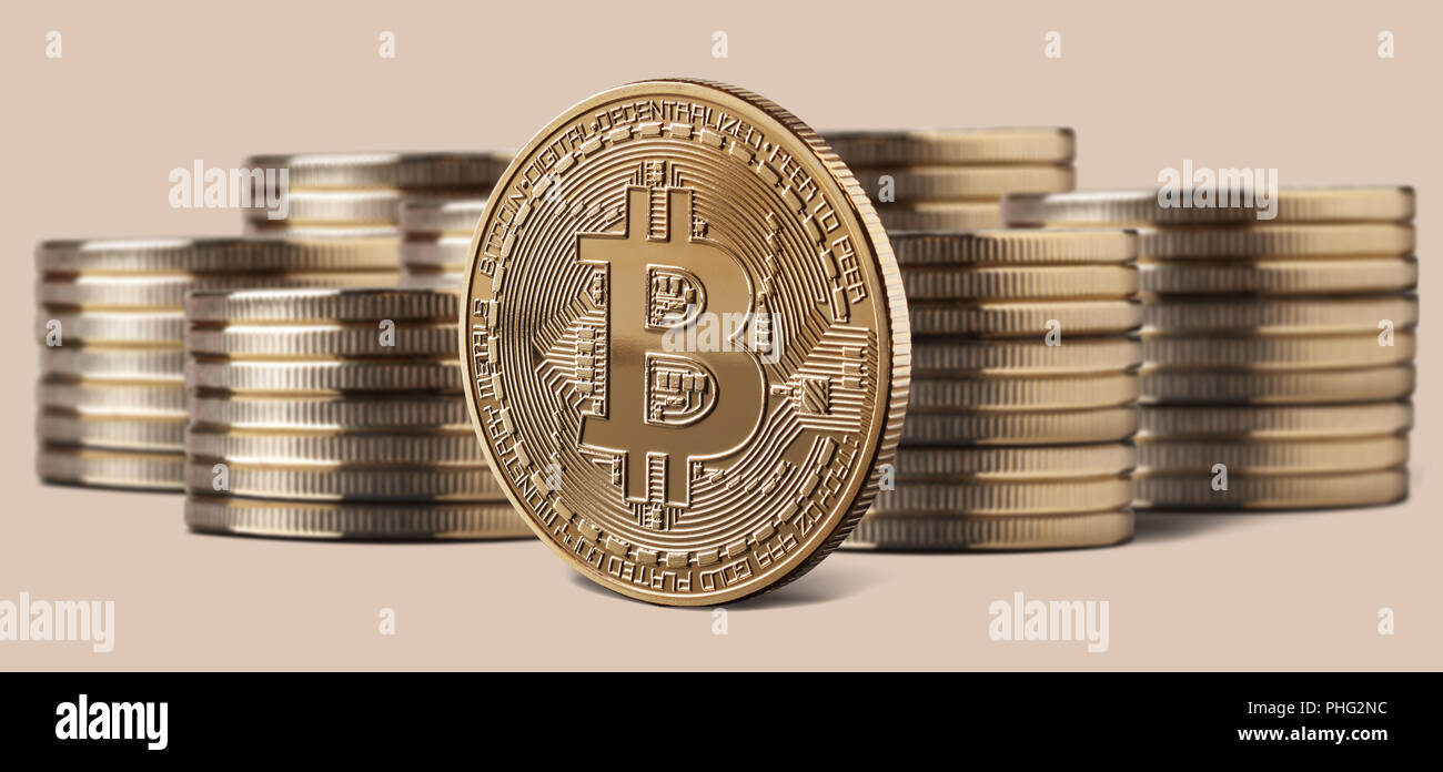 Single bitcoin coin standing in front of stacks of coins Stock Photo - Alamy