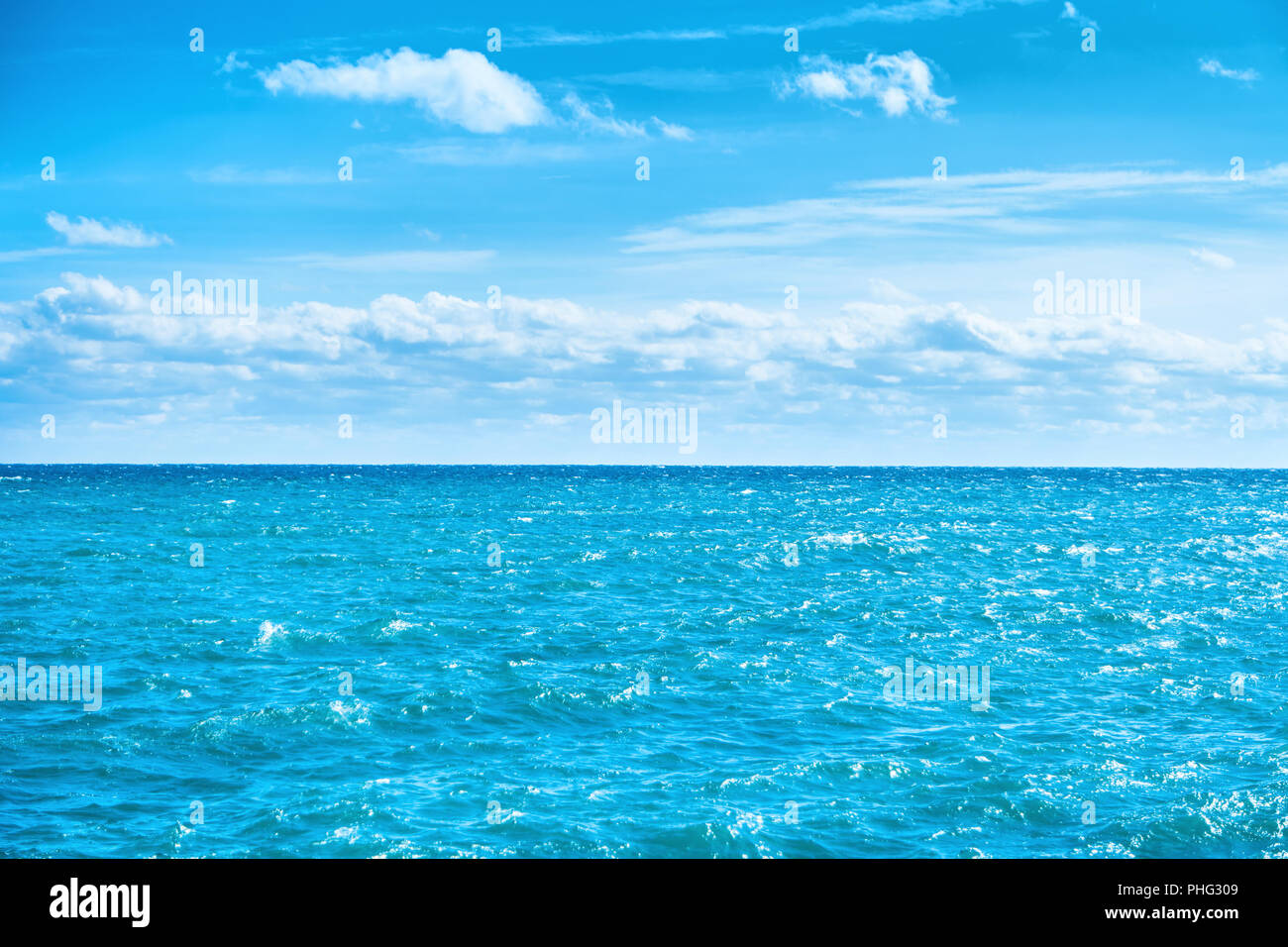 Sea water and blue sky with white clouds Stock Photo