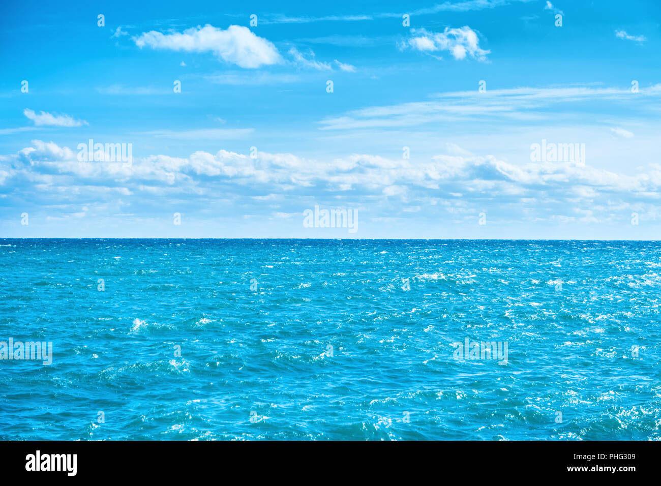 Sea water and blue sky with white clouds Stock Photo - Alamy