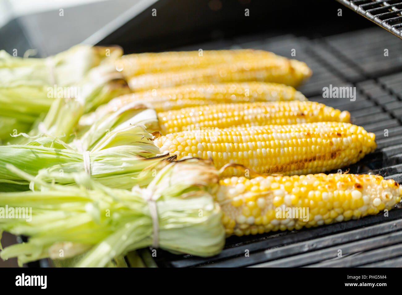 Grilling mexican street corn elote on outdoor gas grill Stock Photo Alamy