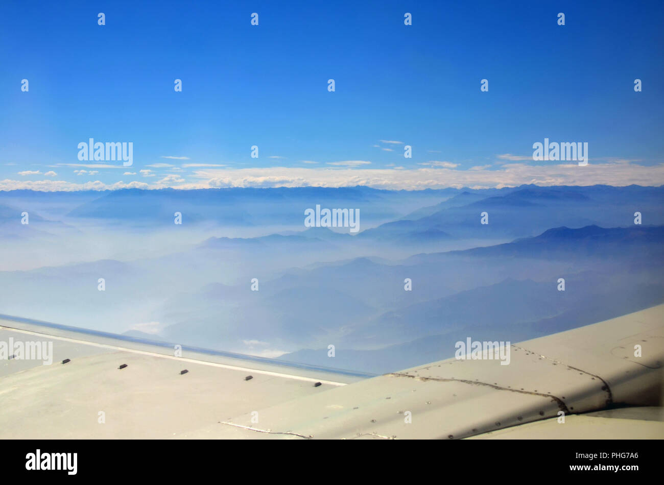 Mountains under plane wing Stock Photo