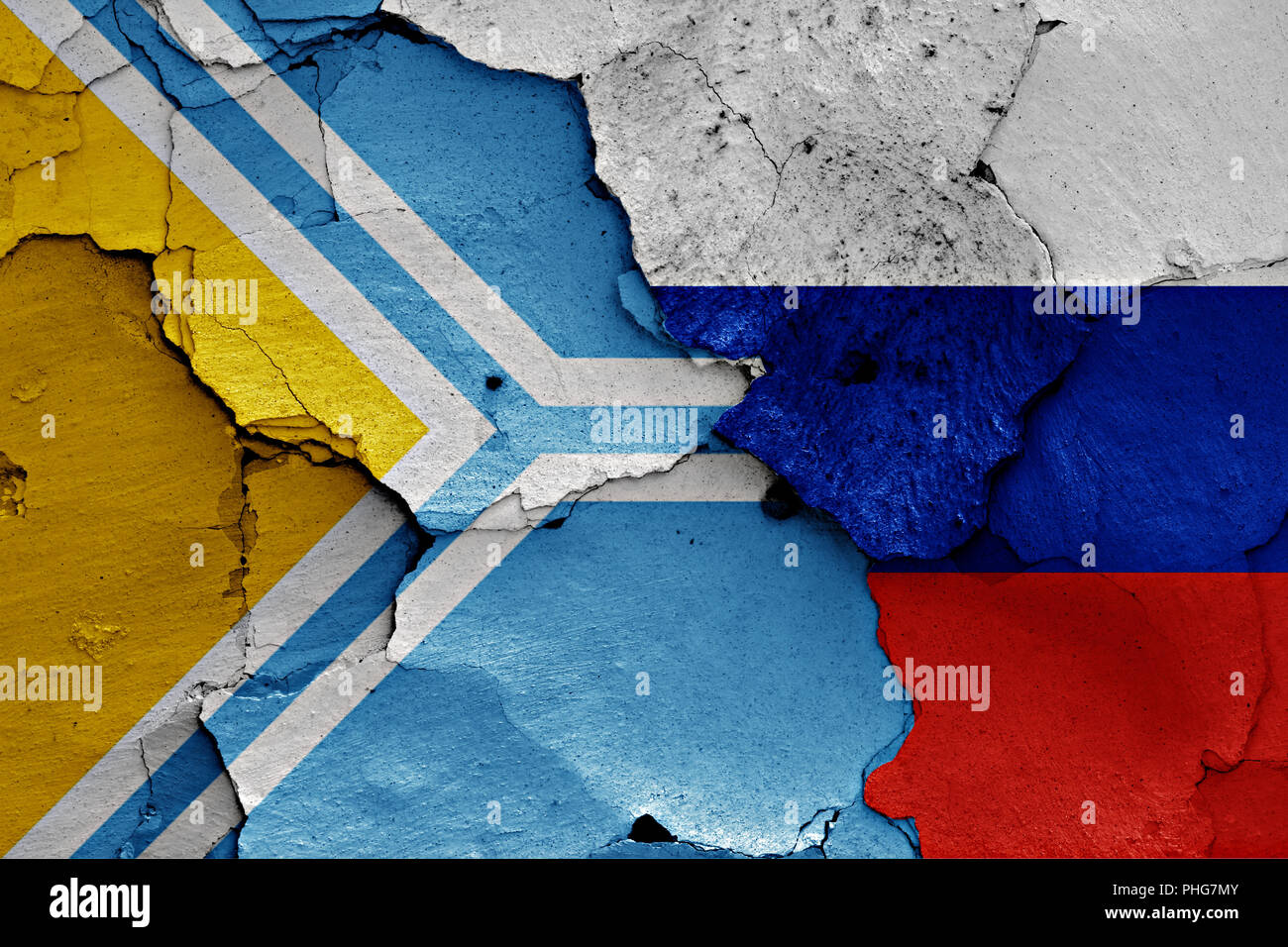 flag of Tuva and Russia painted on cracked wall Stock Photo